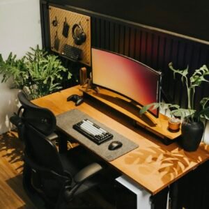Elegant home office setup with ergonomic chair, computer, and plants for a productive workspace.