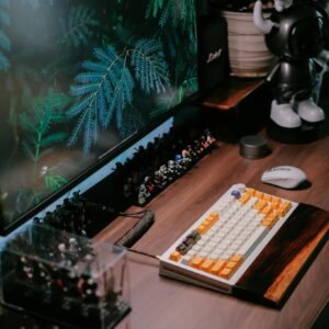 Stylish workspace setup with keyboard, monitor, and decor in a modern office setting.